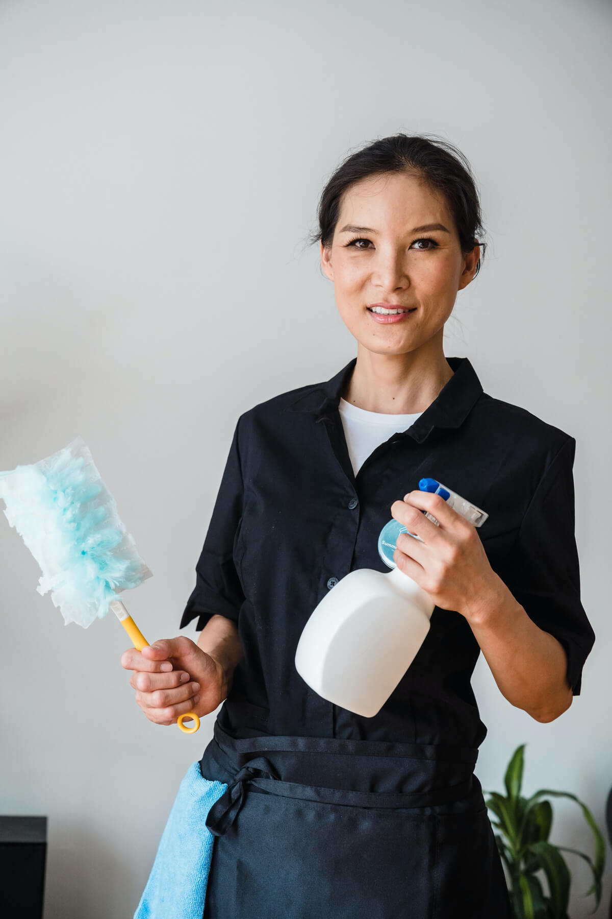 Professional cleaner with cleaning supplies ready to work