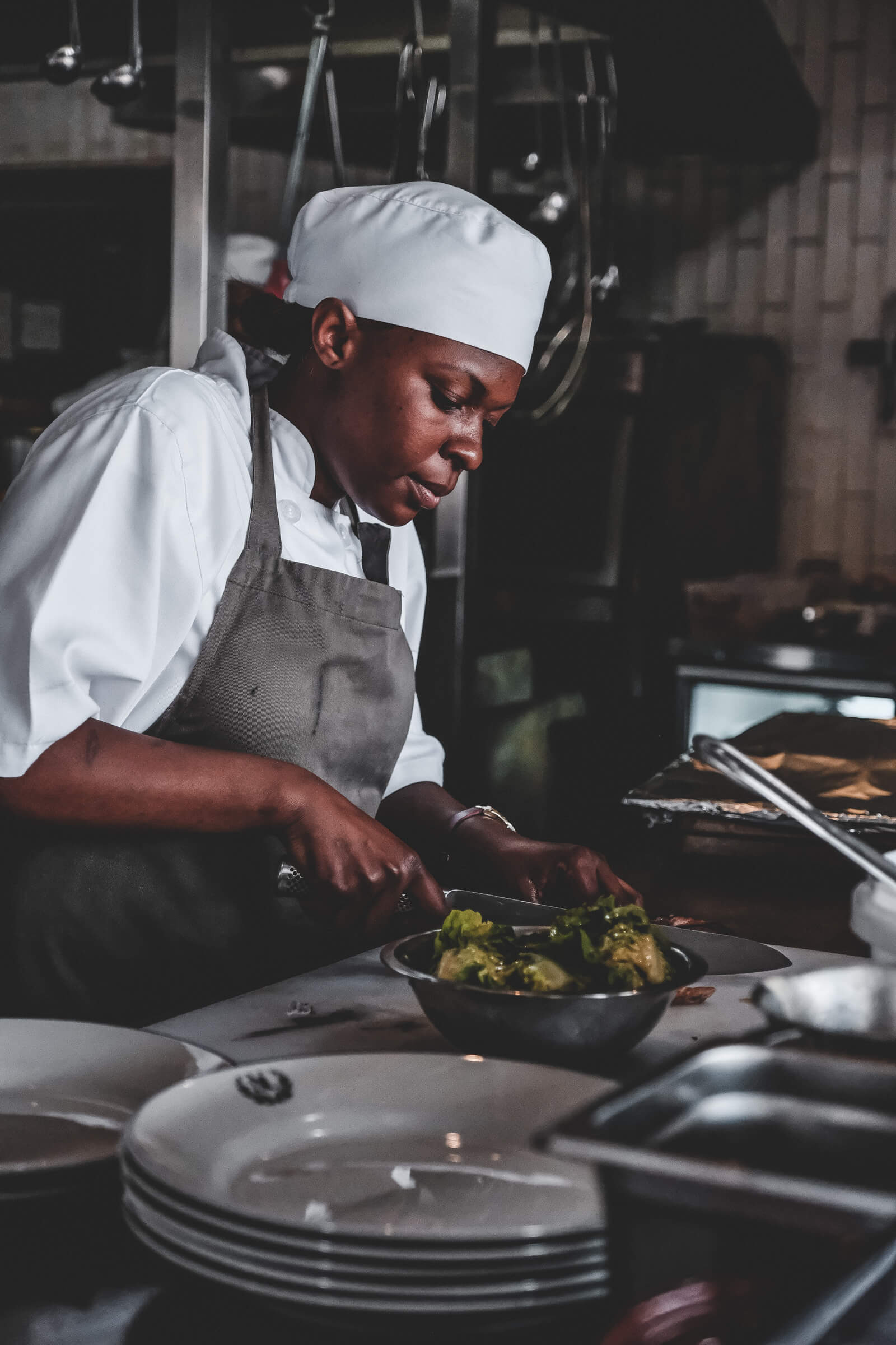 Chef carefully plating food in a professional kitchen