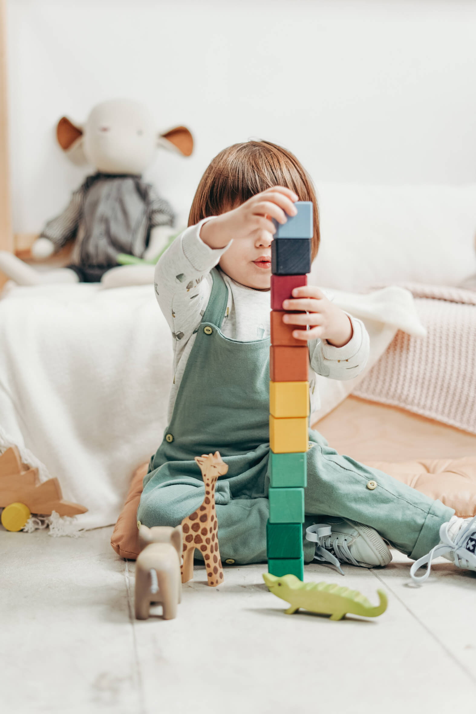 Child engaged in educational play with building blocks
